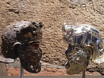 The first-century C.E. helmet alongside a newly created replica