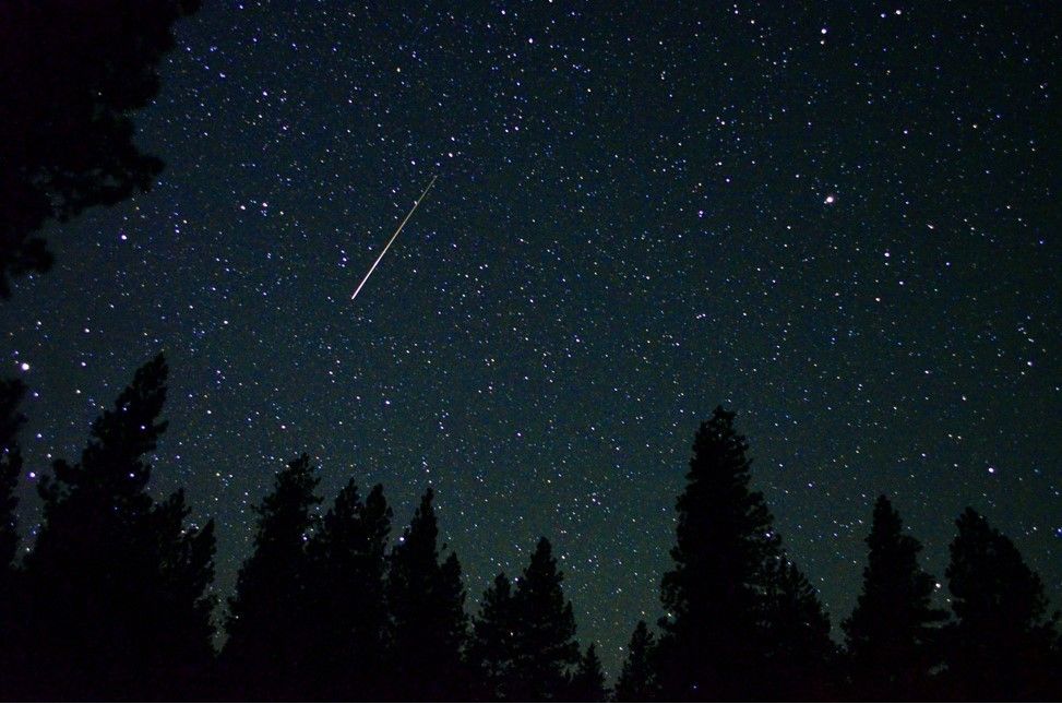 Shooting star in dark night sky