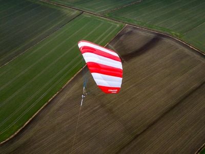 Steered by a computer to loop in the wind, this kite converts wind energy into electricity via a tether attached to a generator on the ground. Currently, such kites can generate enough electricity to power 60 average US households.