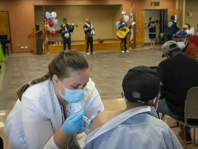 A pharmacist delivers a Covid-19 booster shot in Chicago during a clinic for seniors.