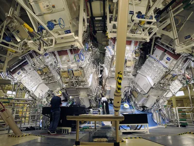 Engineers work outside the structure where the array of lasers at the National Ignition Facility at Lawrence Livermore Laboratory are focused.